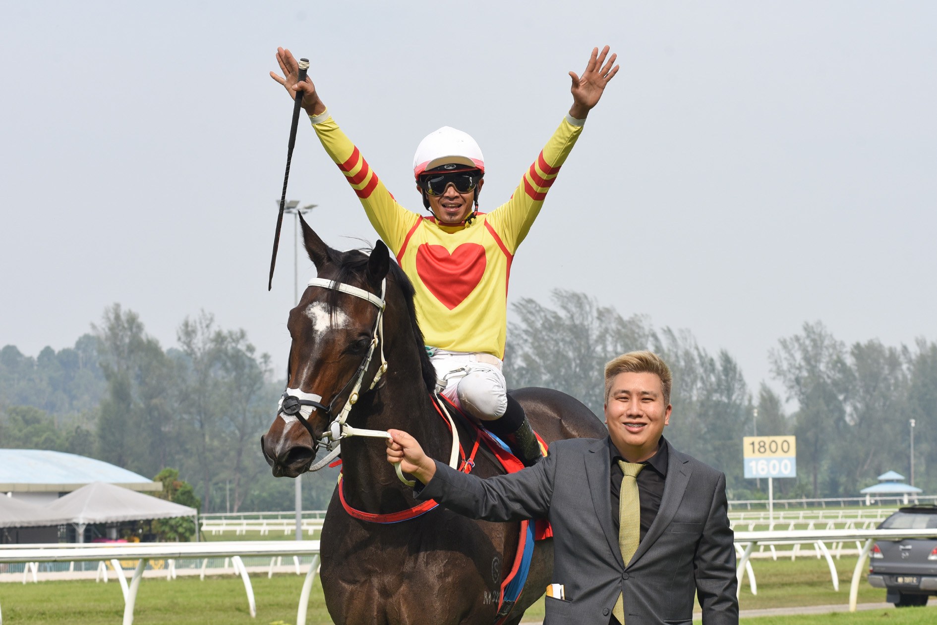 Trainer HY Cheng leading in a winner, jockey celebrating